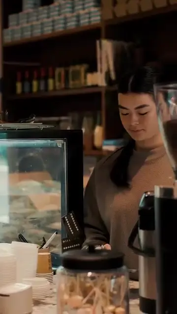 A Wilburs barista at work behind the cafe counter.